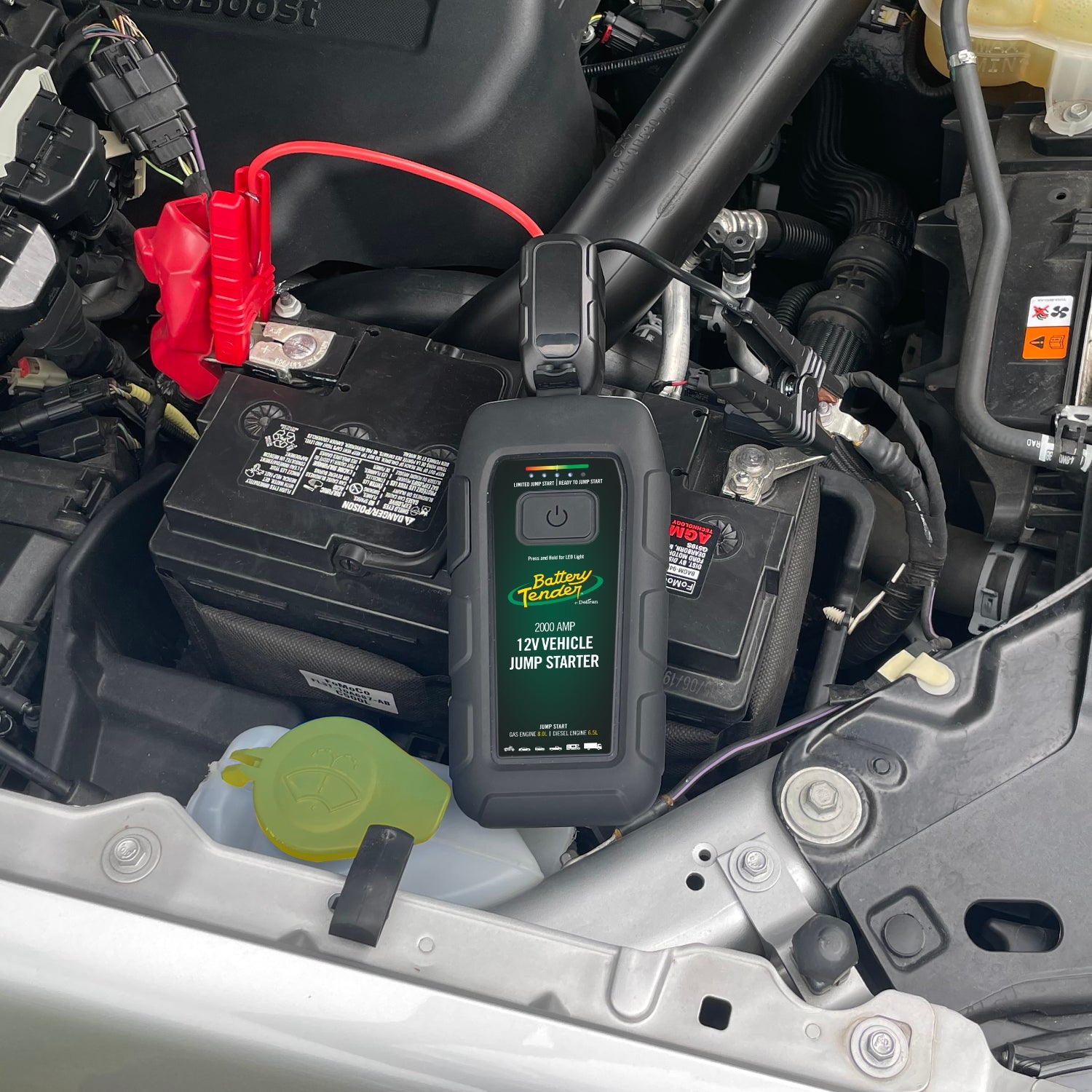 2000 AMP jump starter on top of a vehicle battery.