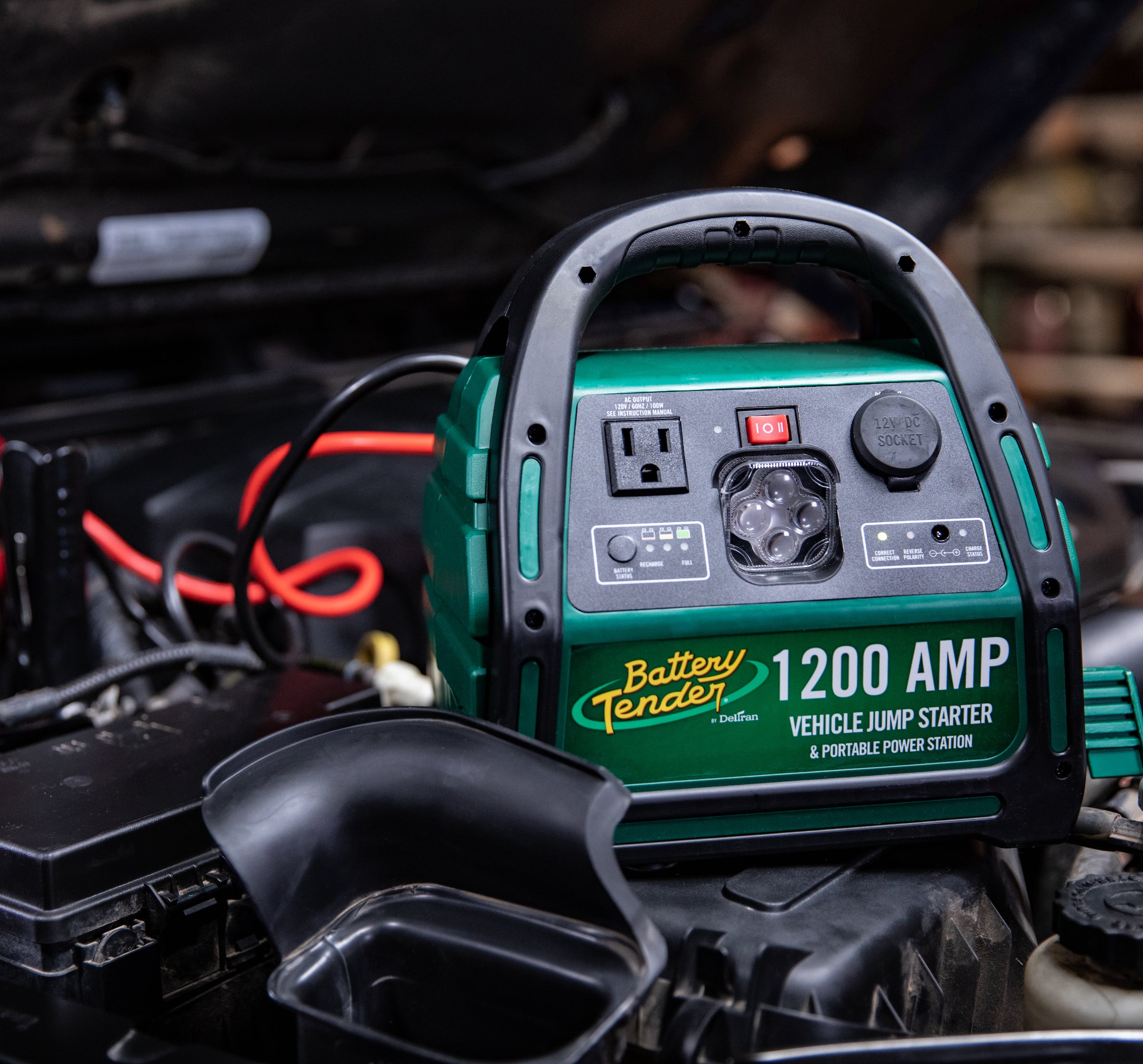 1200 AMP jump starter connected to a vehicle battery.